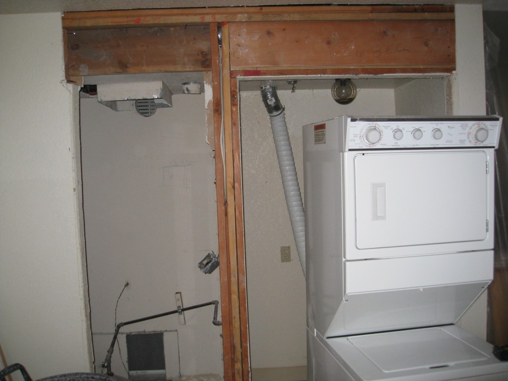 The two doors to a single room serving as a laundry, furnace, and pantry.